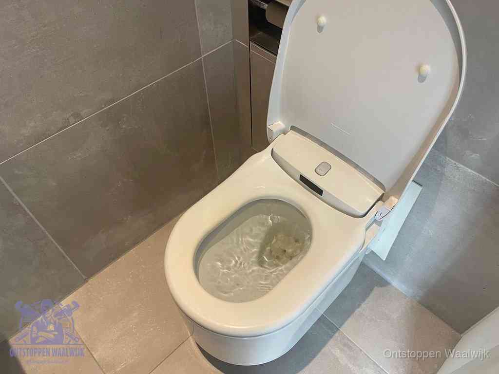 Een toiletpot vol troebel water met drijvend papier en restanten, de meest voorkomende oorzaak van een verstopte wc in Waalwijk